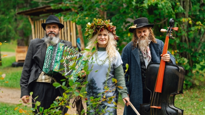 Divi vīrieši ar mūzikas instrumentiem, pa vidu sieviete ar vainagau galvā